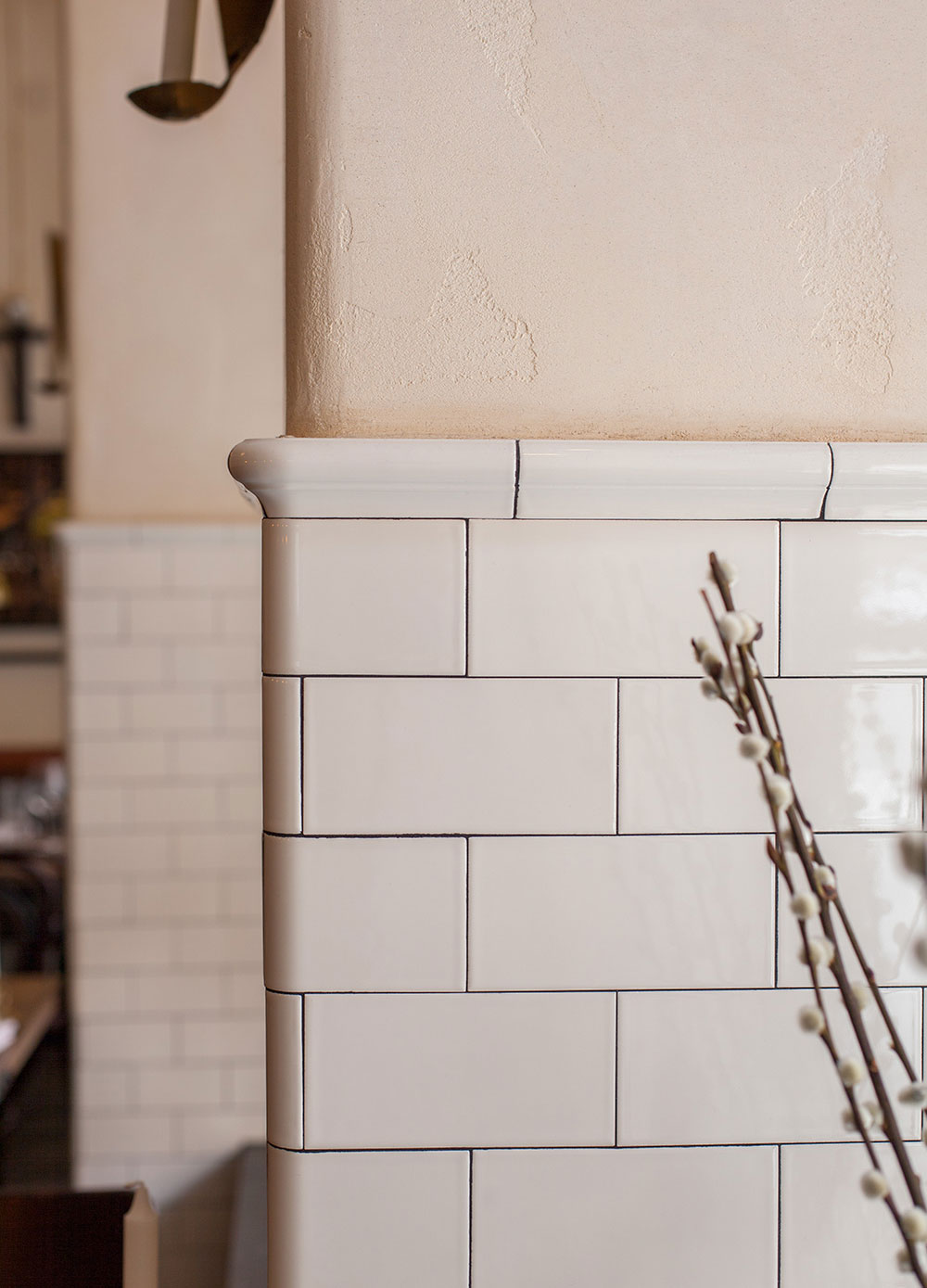 Utskjutande v&auml;gg, kaklad och f&ouml;rsedd med kr&ouml;nlist.