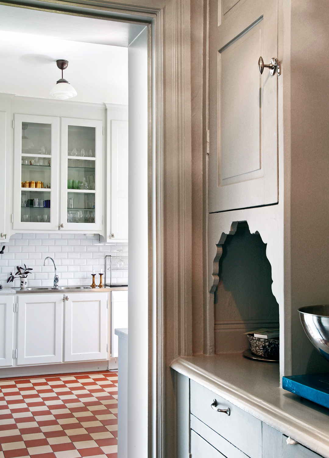 Serveringsg&aring;ng ut till ett k&ouml;k med r&ouml;dvitrutigt klinkergolv.