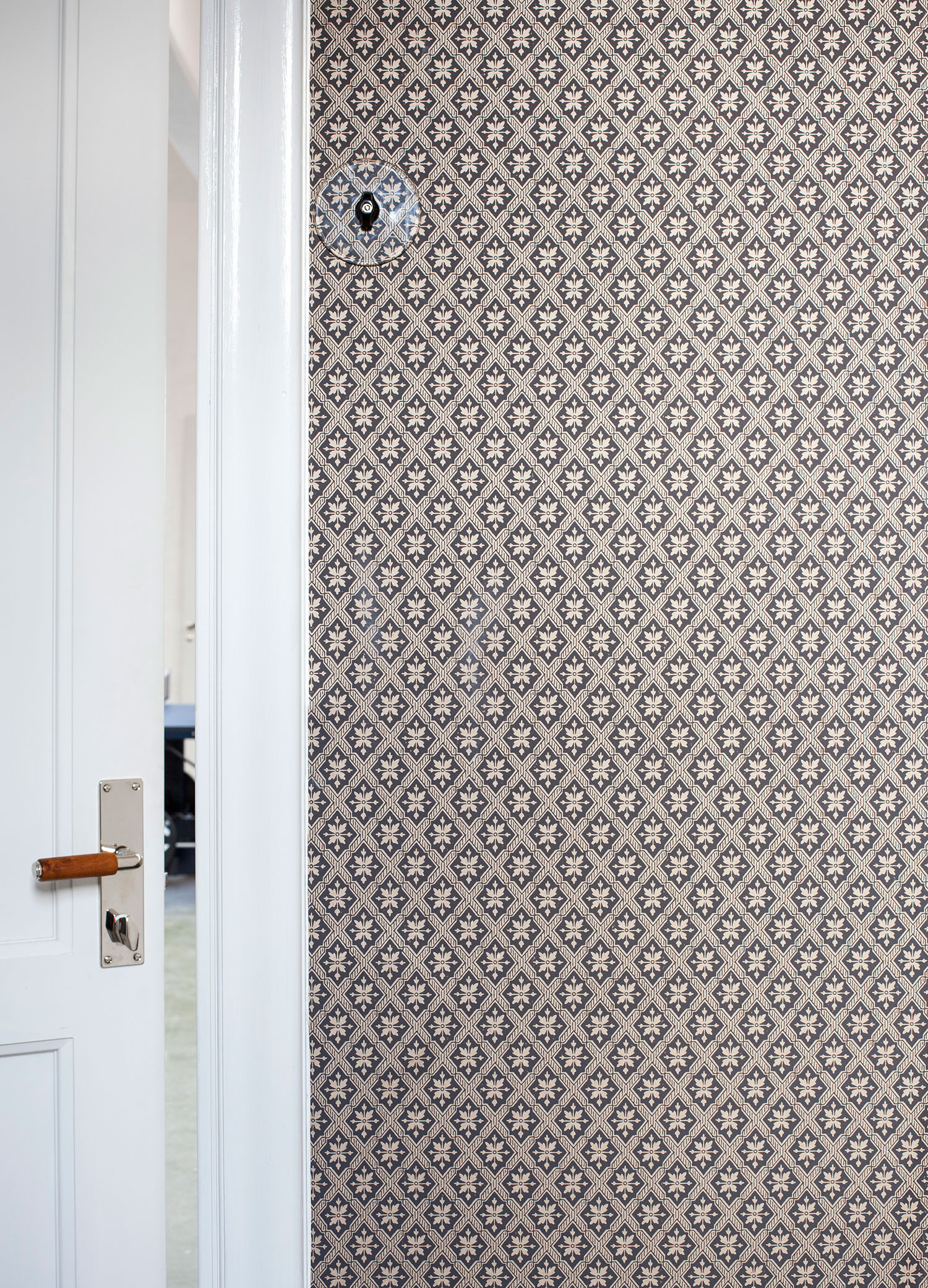 Tapetserad v&auml;gg i svart med en vit spegeld&ouml;rr